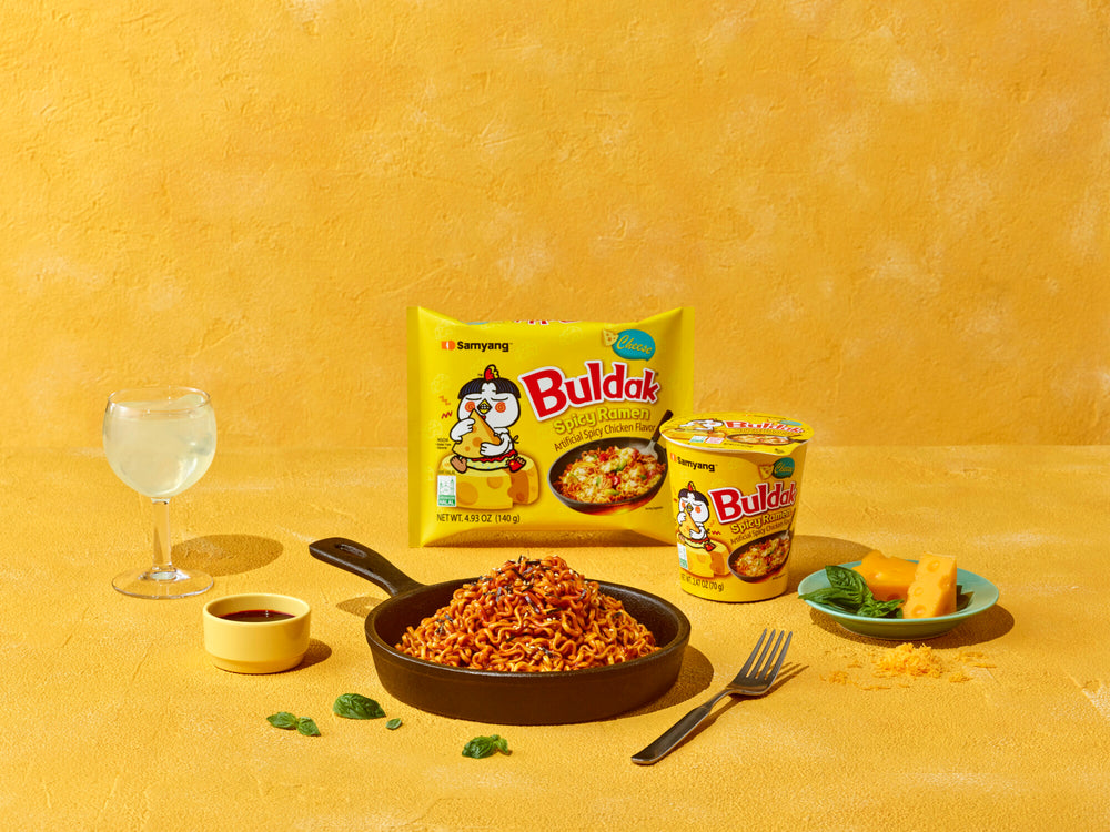 Buldak instant noodles packaging with a bowl of noodles on a yellow background